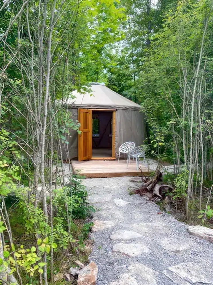 Yurt-down-stone-path-in-forest