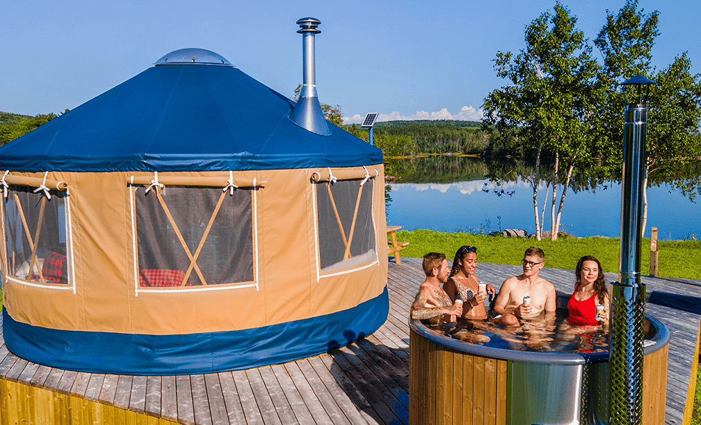 Yurta with hot tub outdoors near a lake, surrounded by trees and scenic landscape. Perfect for relax.