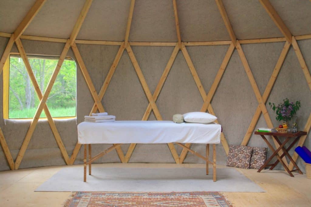 Massage table in yurt with window