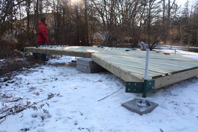 Yurta model installed on a wooden deck in an outdoor setting with snow, showcasing durable construct.