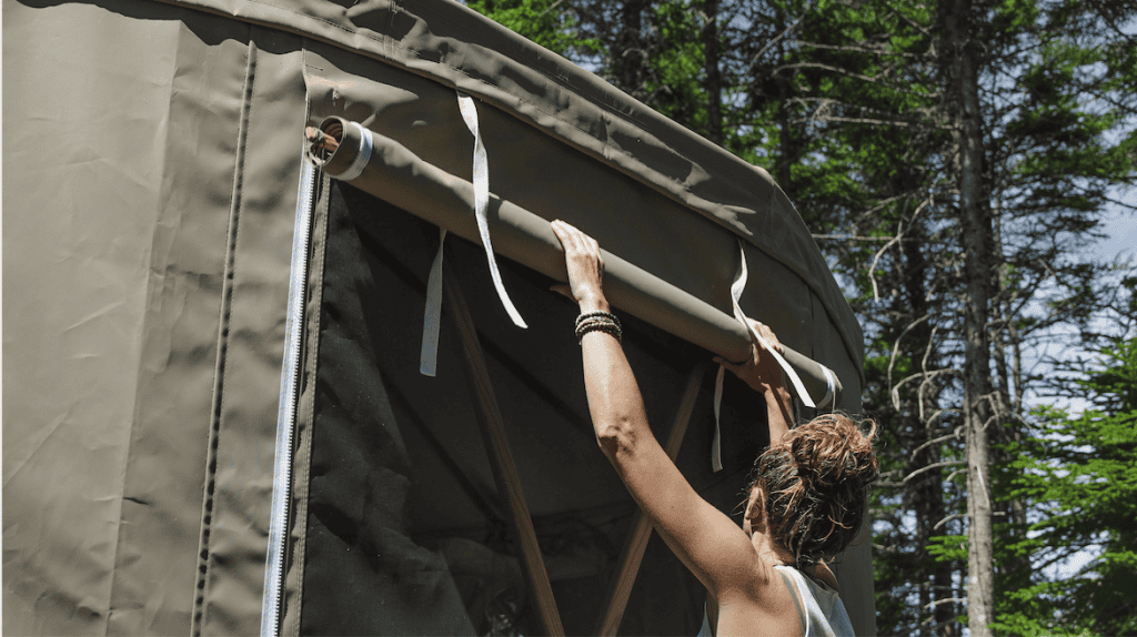 Woman opening yurt window