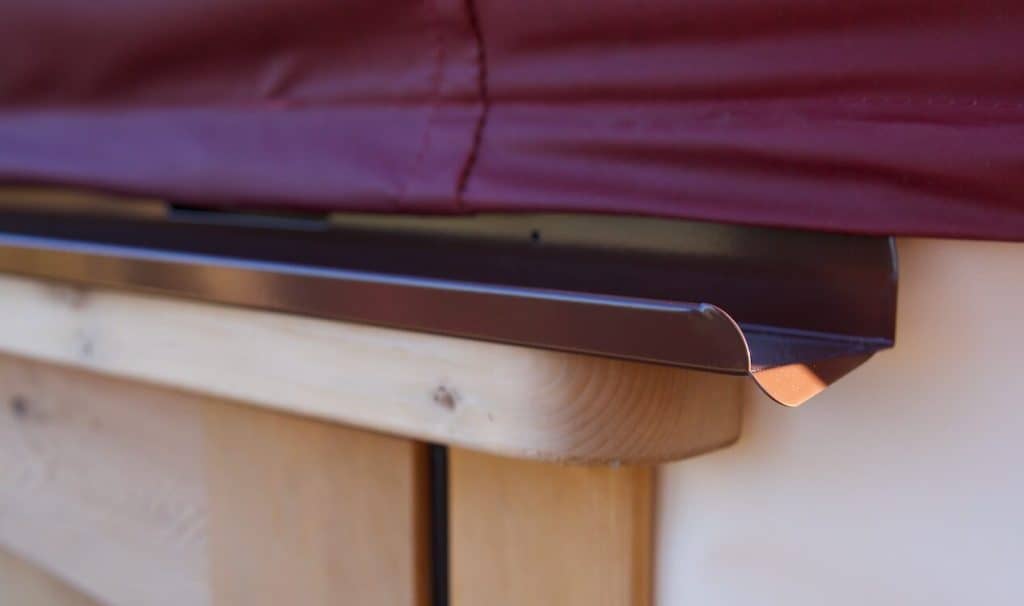 Close up of metal rain diverter on yurt door