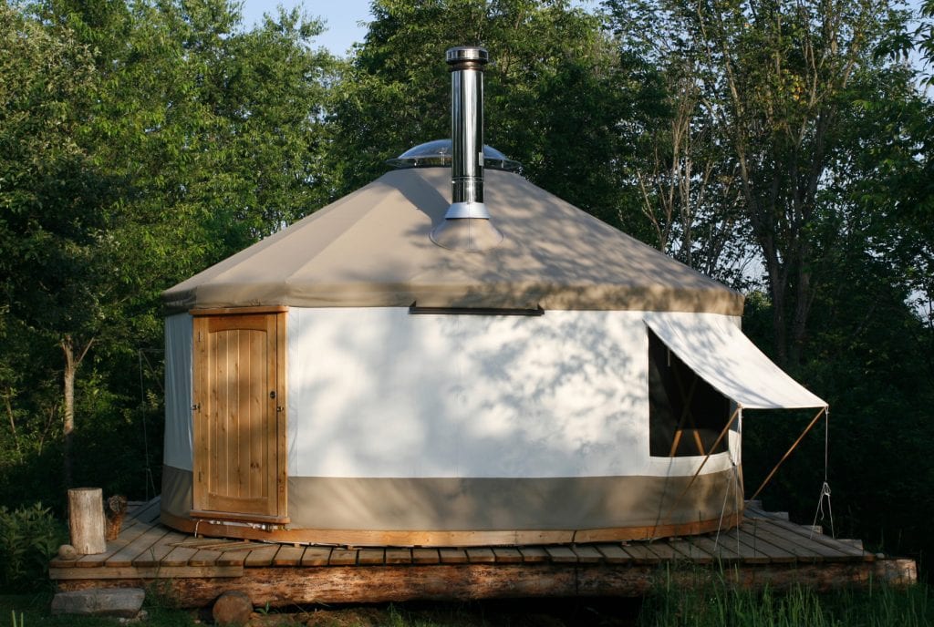 Summer yurt with open window and awning